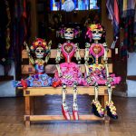 Three puppets dressed like day of the dead.