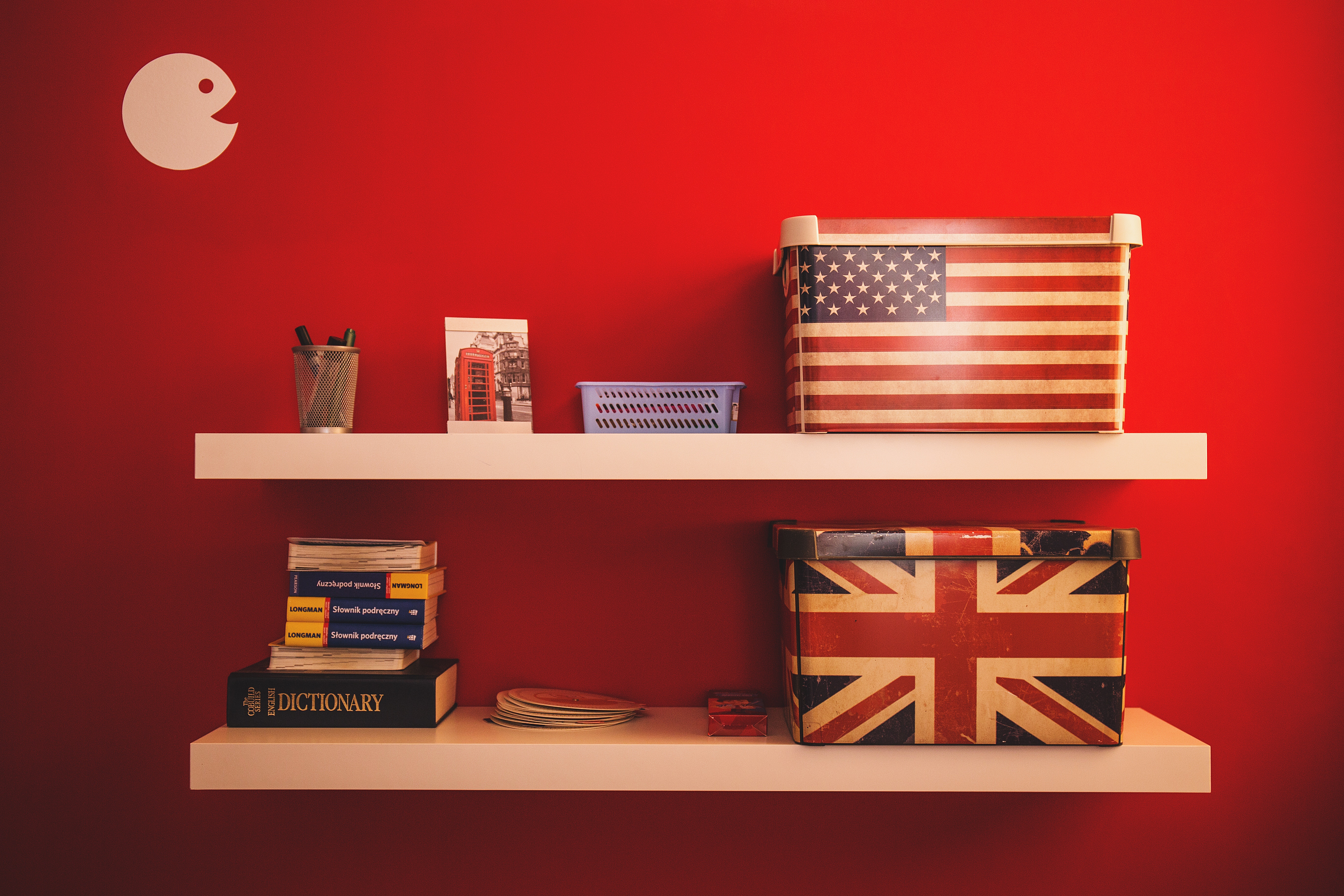 Boxes wrapped in US and UK flags on a shelf.
