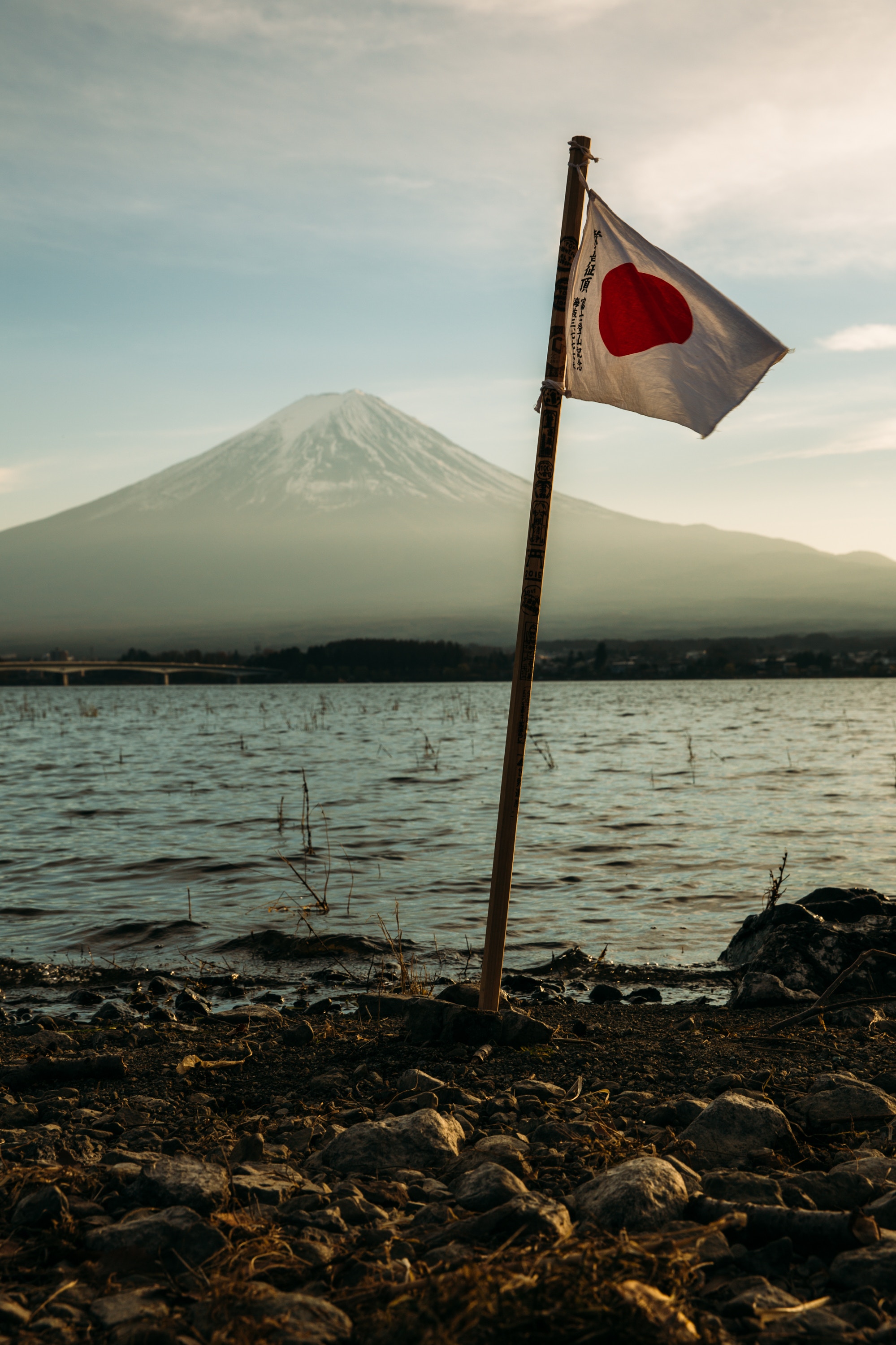 Flag of Japan in front of mountain.