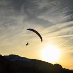 Person parachuting during a sunset.